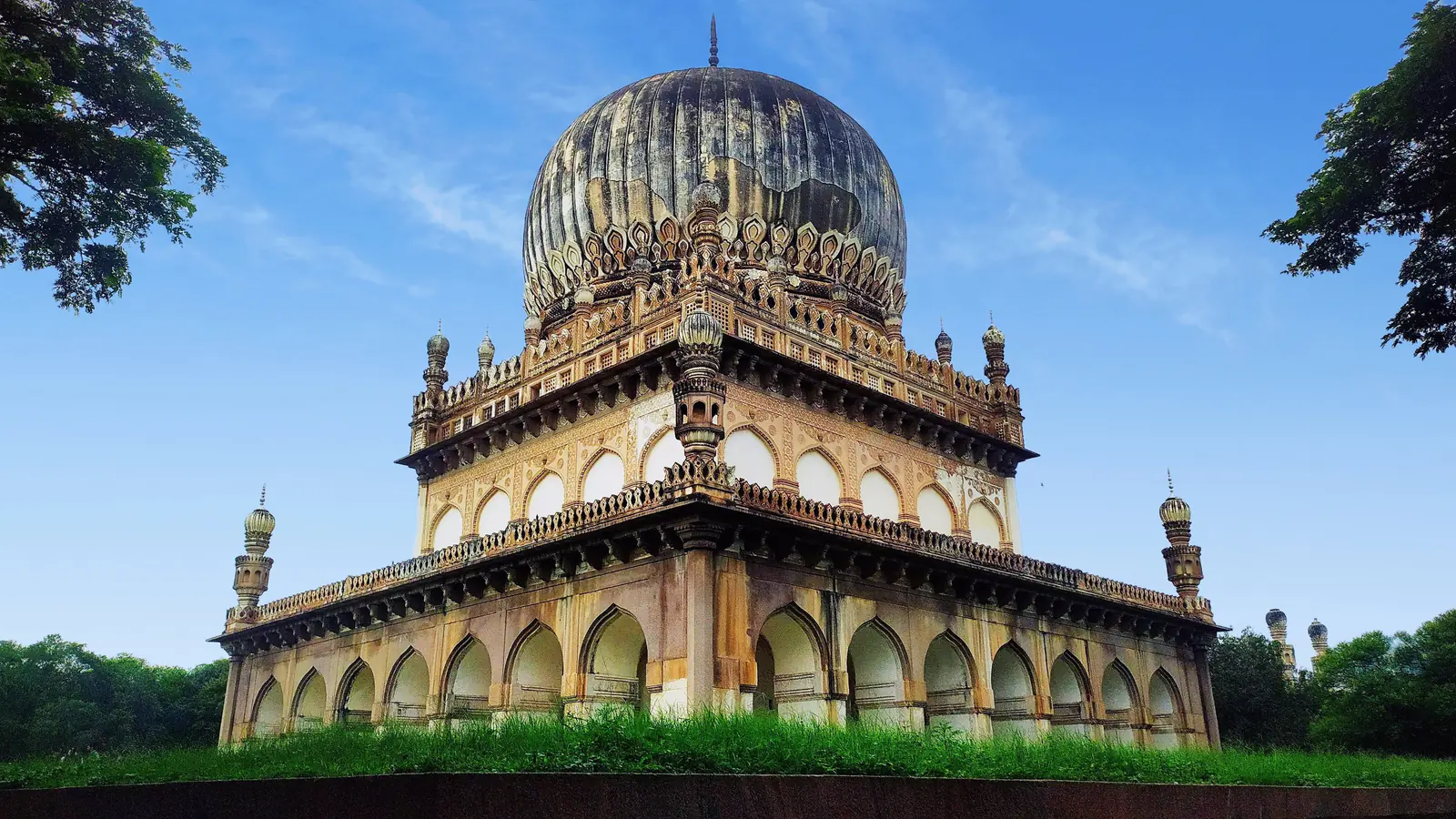 Domed stone mausoleum in Hyderabad's Qutb Shahi tomb complex.