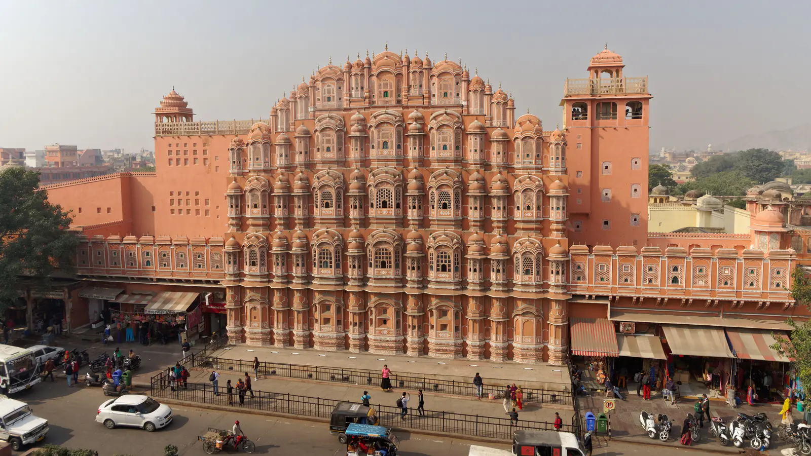 Pink sandstone windows covering the facade of Jaipur's Hawa Mahal.