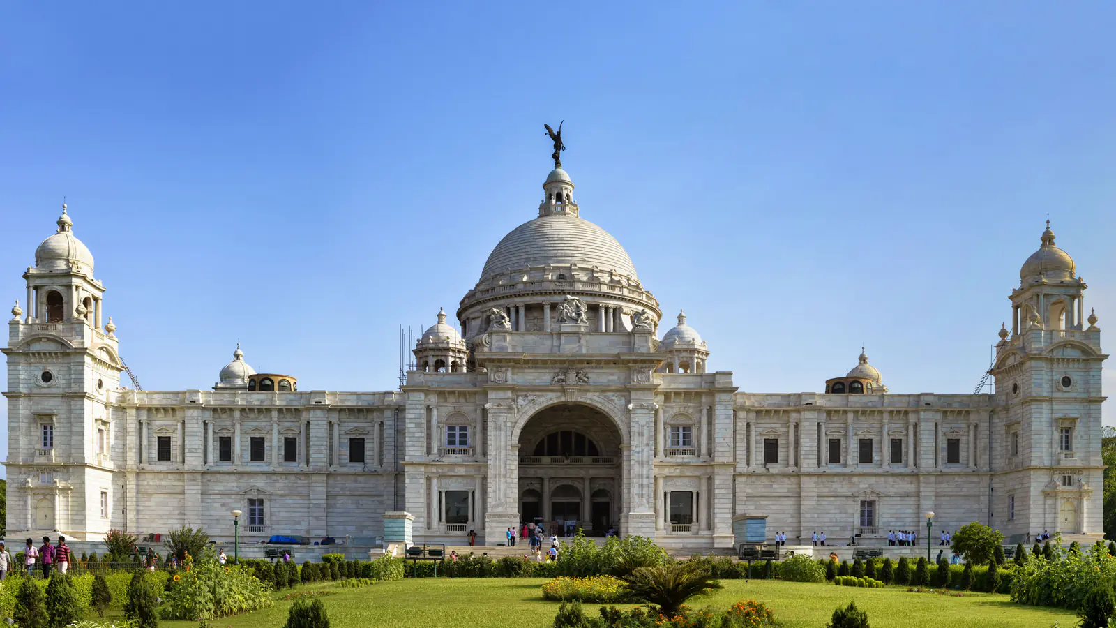 White marble Victoria Memorial beyond its formal garden in Kolkata.