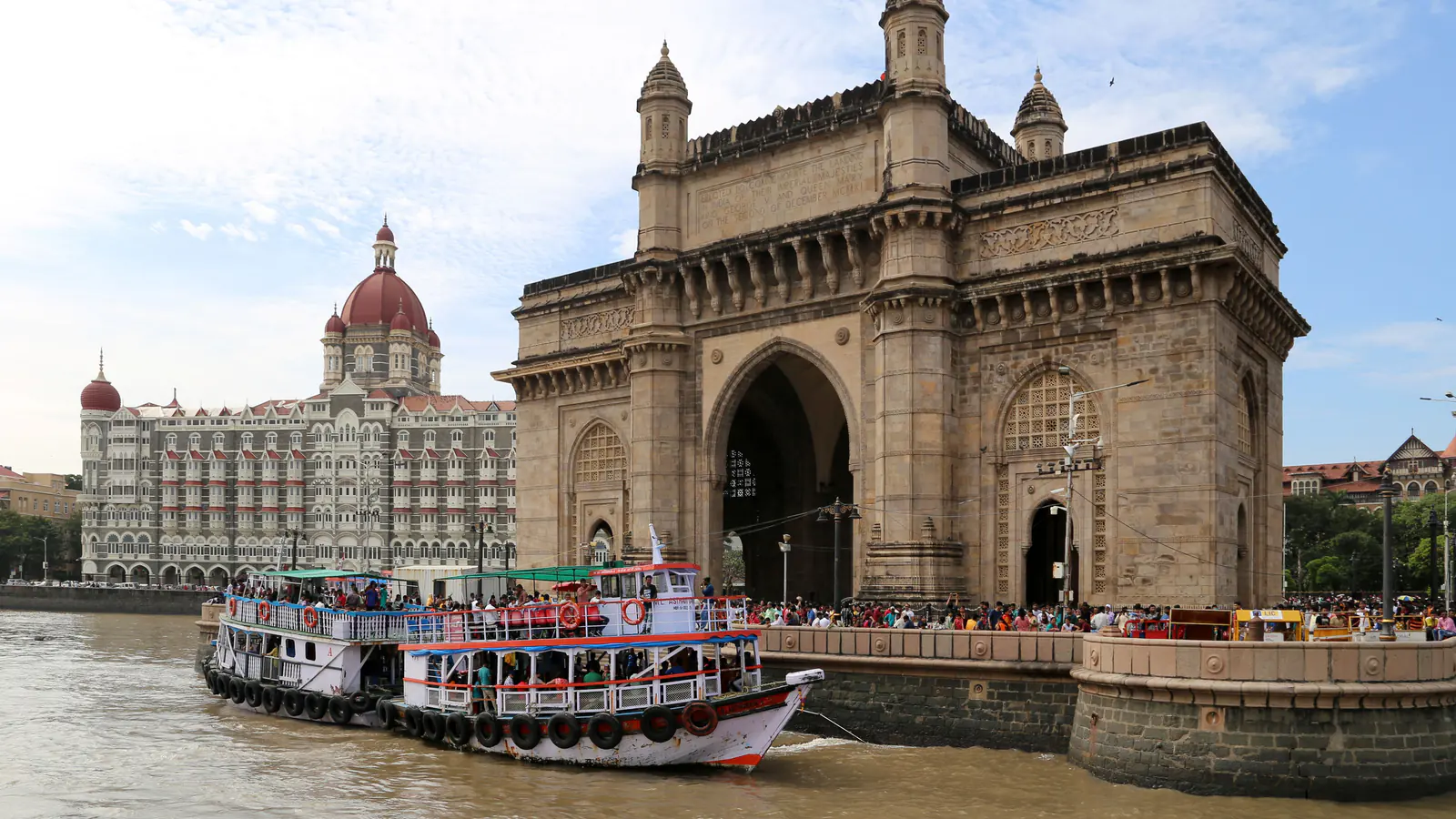 Stone arch of the Gateway of India beside Mumbai Harbour.