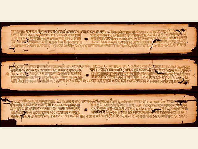 Three leaves of a Brihajjataka palm-leaf manuscript copied in 1399 CE